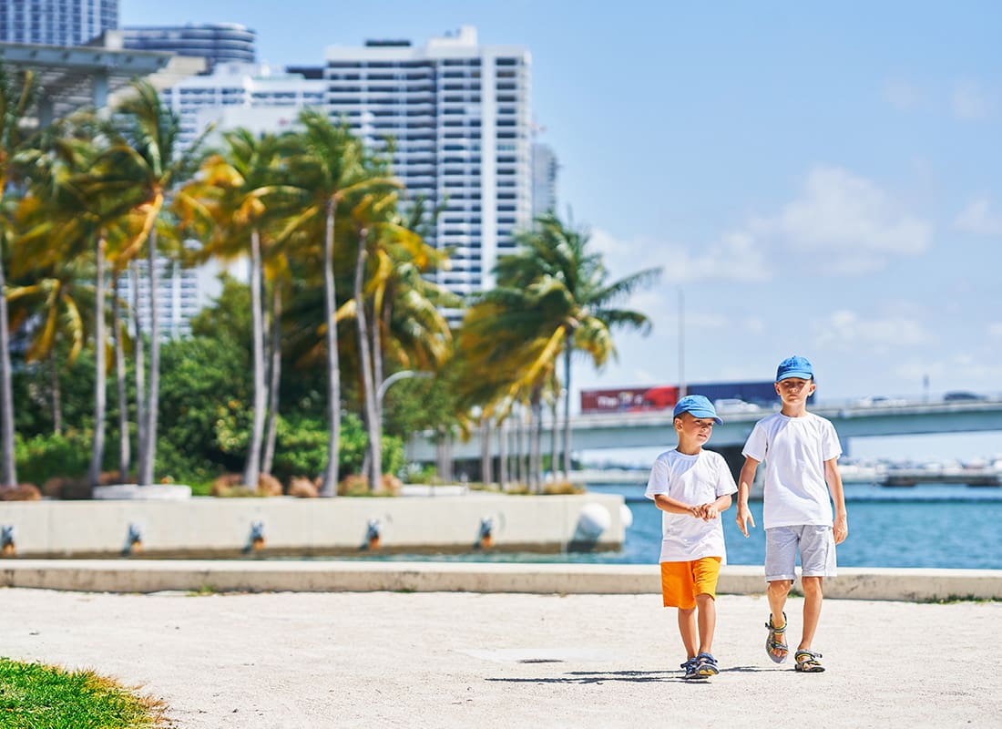 Sun City Center, FL - Two Young Boys Walking in a Marina on a Sunny Day